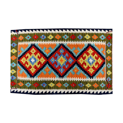 Close-up of Afghan Chobi Kilim wool rug showing turquoise triple diamond panel with rust, ivory and olive border motifs