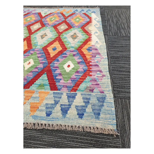 Angled detail of Afghan Chobi Kilim showing fringe, geometric border, and handwoven flatweave pattern, 115 x 86 cm