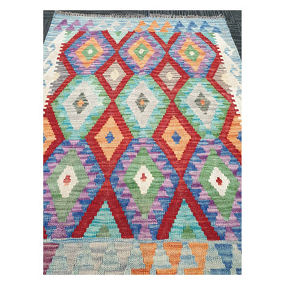 Close-up of Chobi Kilim rug with diamond trellis motifs in coral red, mint green, lilac, and powder blue, 115 x 86 cm