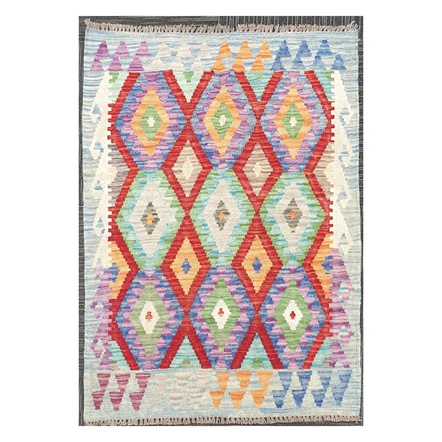 Full view of Afghan Chobi Kilim wool rug with prismatic diamond trellis on an ivory ground, 115 x 86 cm