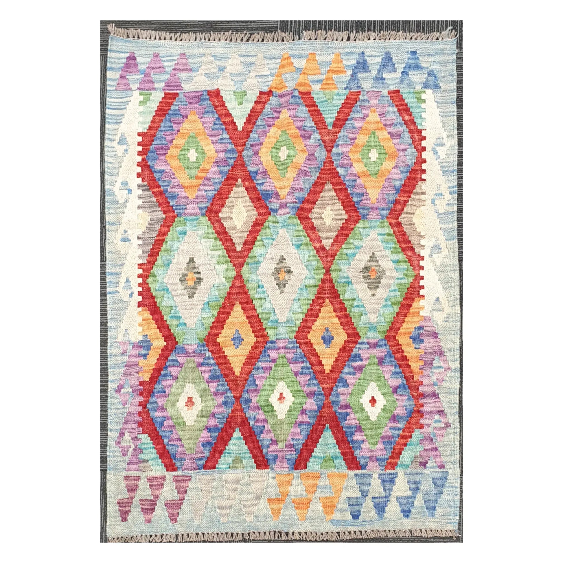 Full view of Afghan Chobi Kilim wool rug with prismatic diamond trellis on an ivory ground, 115 x 86 cm
