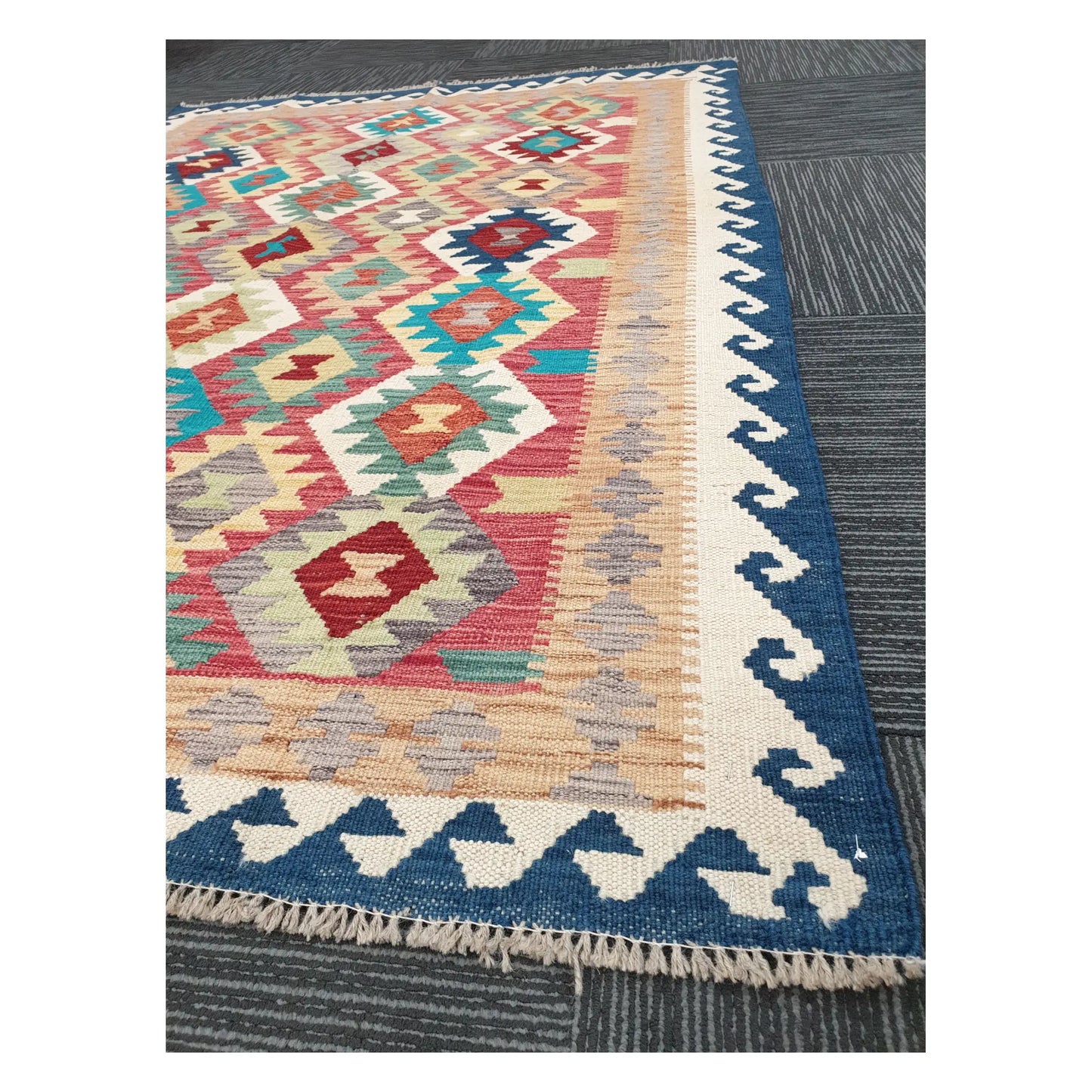 Angled detail of Afghan Chobi Kilim showing fringe, blue border, and handwoven geometric pattern, 178 x 128 cm