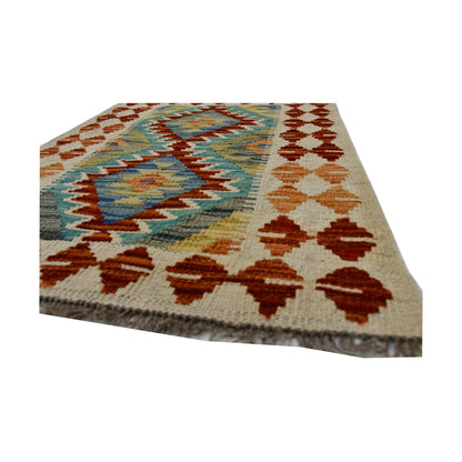 Angled corner and fringe detail of Afghan Chobi Kilim wool rug showing handwoven flatweave texture and rust border motifs