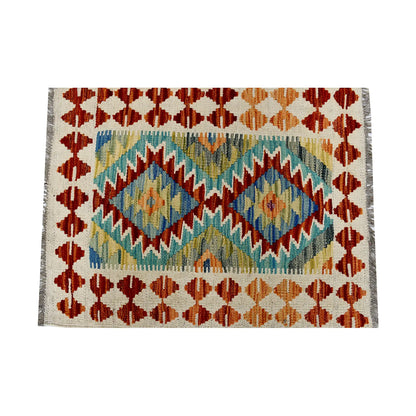 Close-up of Afghan Chobi Kilim wool rug showing teal twin diamond medallions, ivory ground and colourful geometric border