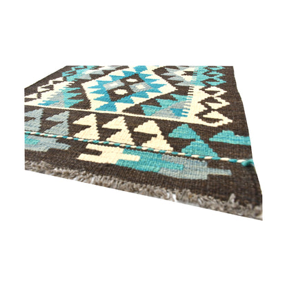 Angled fringe and flatweave detail of Afghan Chobi Kilim wool rug showing charcoal, turquoise, ivory and brown geometric pattern