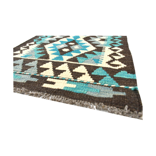 Angled fringe and flatweave detail of Afghan Chobi Kilim wool rug showing charcoal, turquoise, ivory and brown geometric pattern