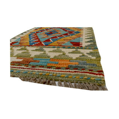 Angled fringe and flatweave detail of Afghan Chobi Kilim wool rug showing teal, rust, olive and orange geometric pattern