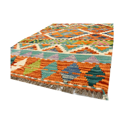 Angled fringe and flatweave detail of Afghan Chobi Kilim wool rug showing rust, teal, sage green and ivory geometry