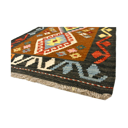 Angled fringe and flatweave detail of Afghan Chobi Kilim wool rug showing rust brown, ivory, orange and charcoal geometry