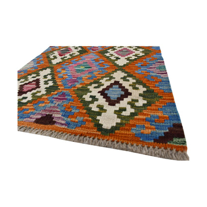 Angled corner and fringe detail of Afghan Chobi Kilim wool rug showing handwoven wool texture and multicolour geometric design