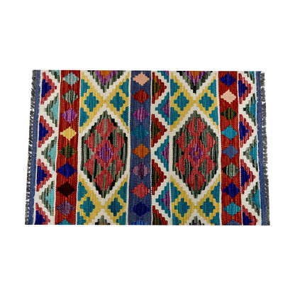 Close-up of Afghan Chobi Kilim wool rug showing teal ivory diamond lattice with rust, yellow and blue tribal motifs
