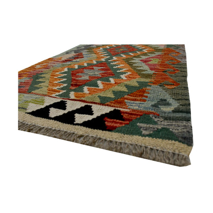 Angled fringe and flatweave detail of Afghan Chobi Kilim wool rug showing sage, orange, ivory and black geometric pattern
