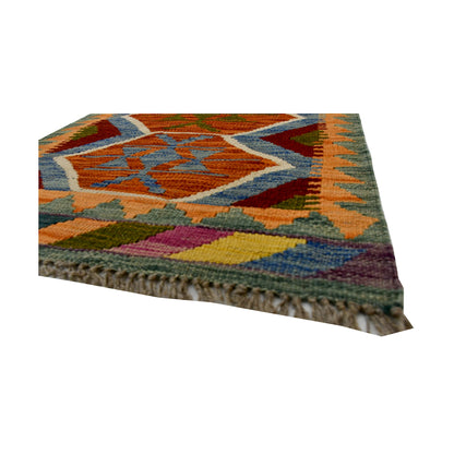 Angled fringe and flatweave detail of Afghan Chobi Kilim wool rug showing rust, blue, olive and geometric border pattern