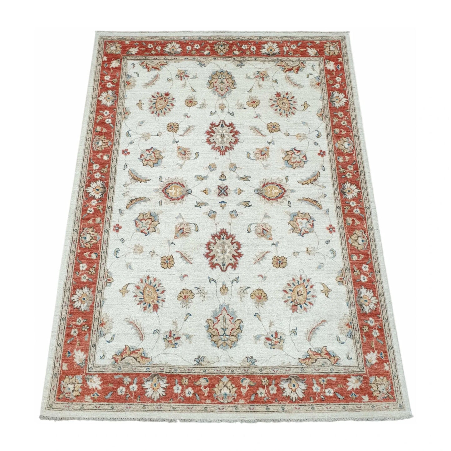 Angled full view of Afghan Chobi red border rug showing floral pattern layout