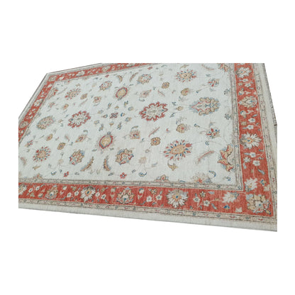 Edge detail of Afghan Chobi red border rug showing wool pile and border pattern