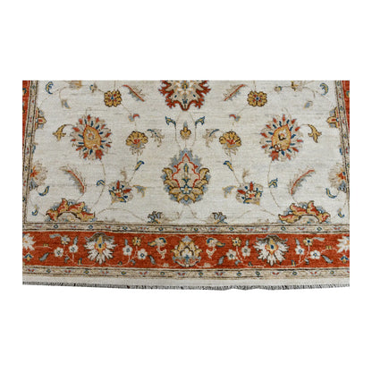 Fringe and end-border detail of Afghan Chobi rug with rust-red floral borderwork and soft blue-green accents