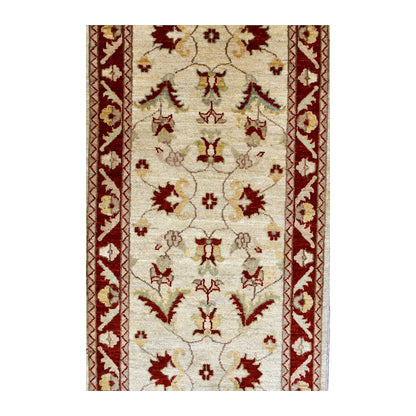 Field detail of Afghan Chobi runner with paired red blossoms, curling vines and muted gold and green motifs