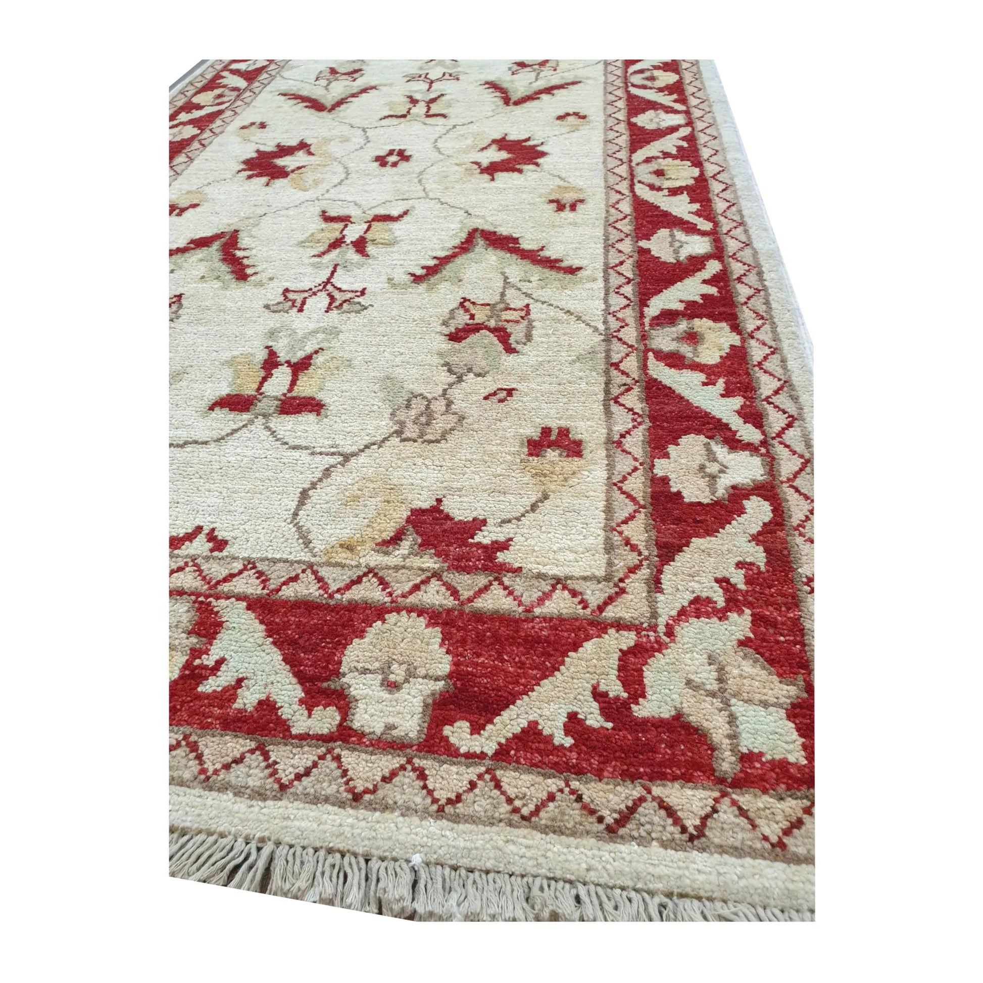Border detail of Afghan Chobi red border runner showing wool pile and fringe