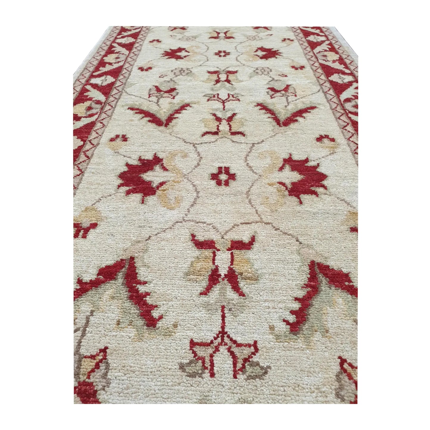 Field detail of Afghan Chobi runner showing beige floral vine pattern and red border