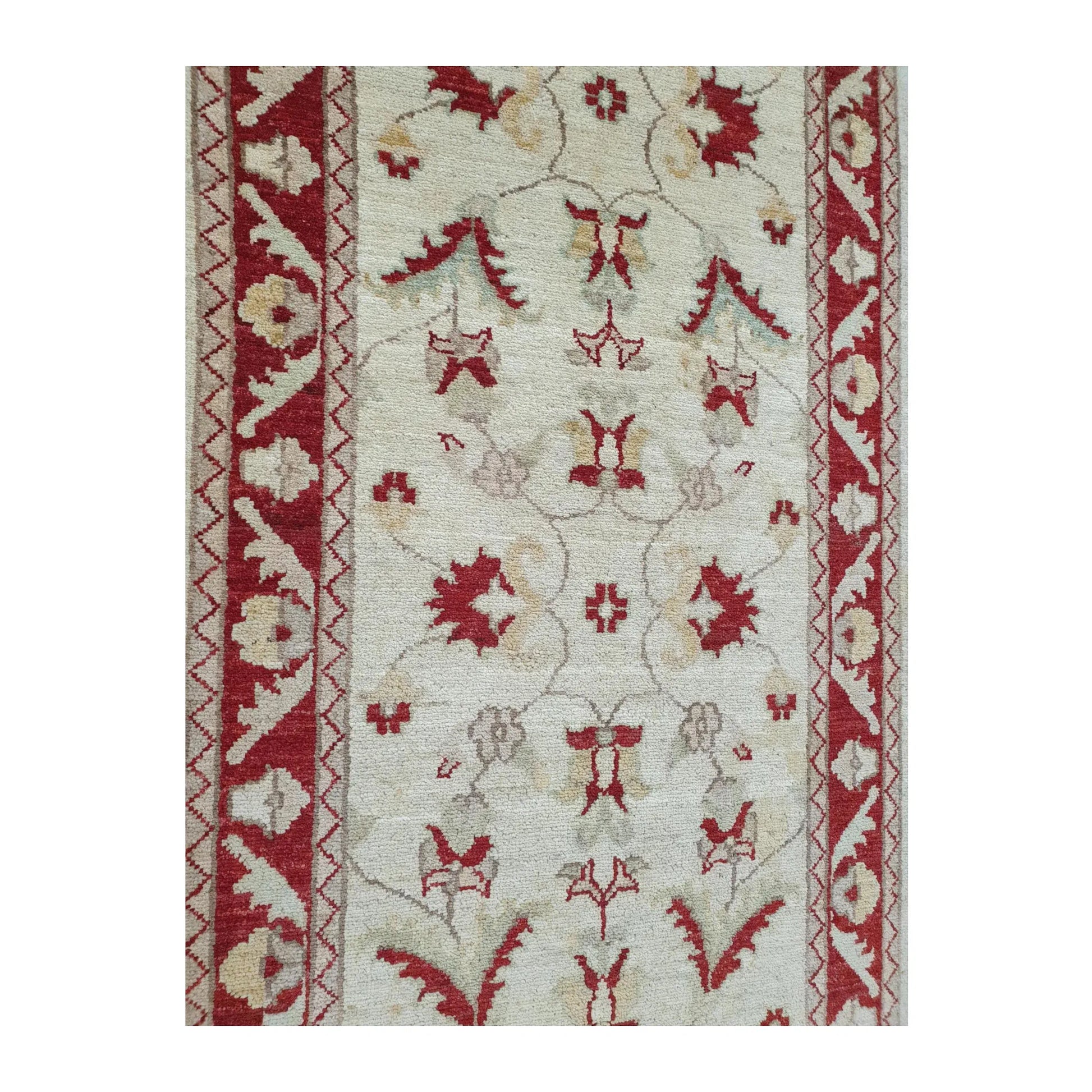 Side pattern detail of Afghan Chobi red border runner showing floral motifs and wool texture
