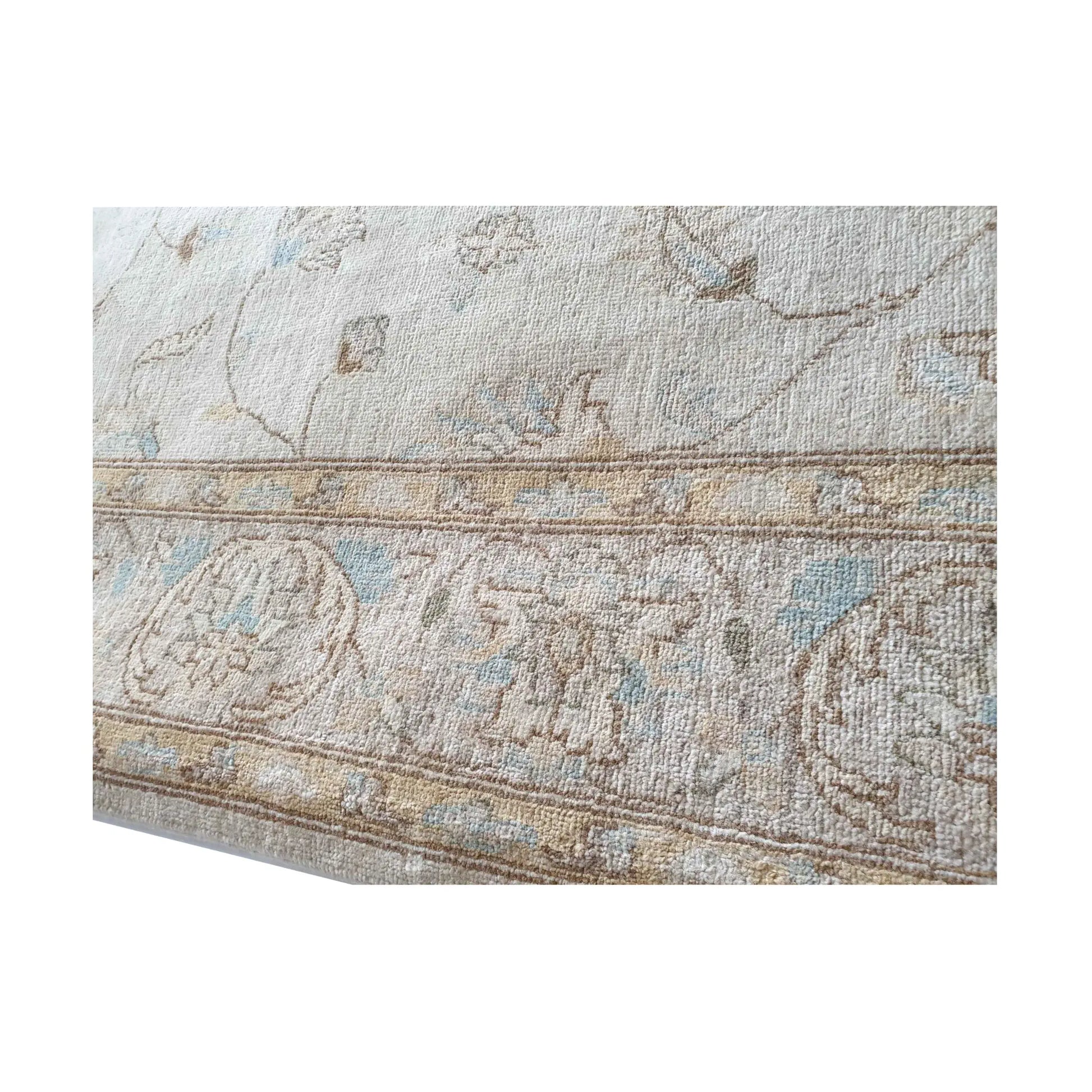 Edge detail of Afghan Chobi soft beige rug showing border and wool texture