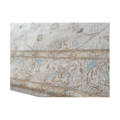 Edge detail of Afghan Chobi soft beige rug showing border and wool texture