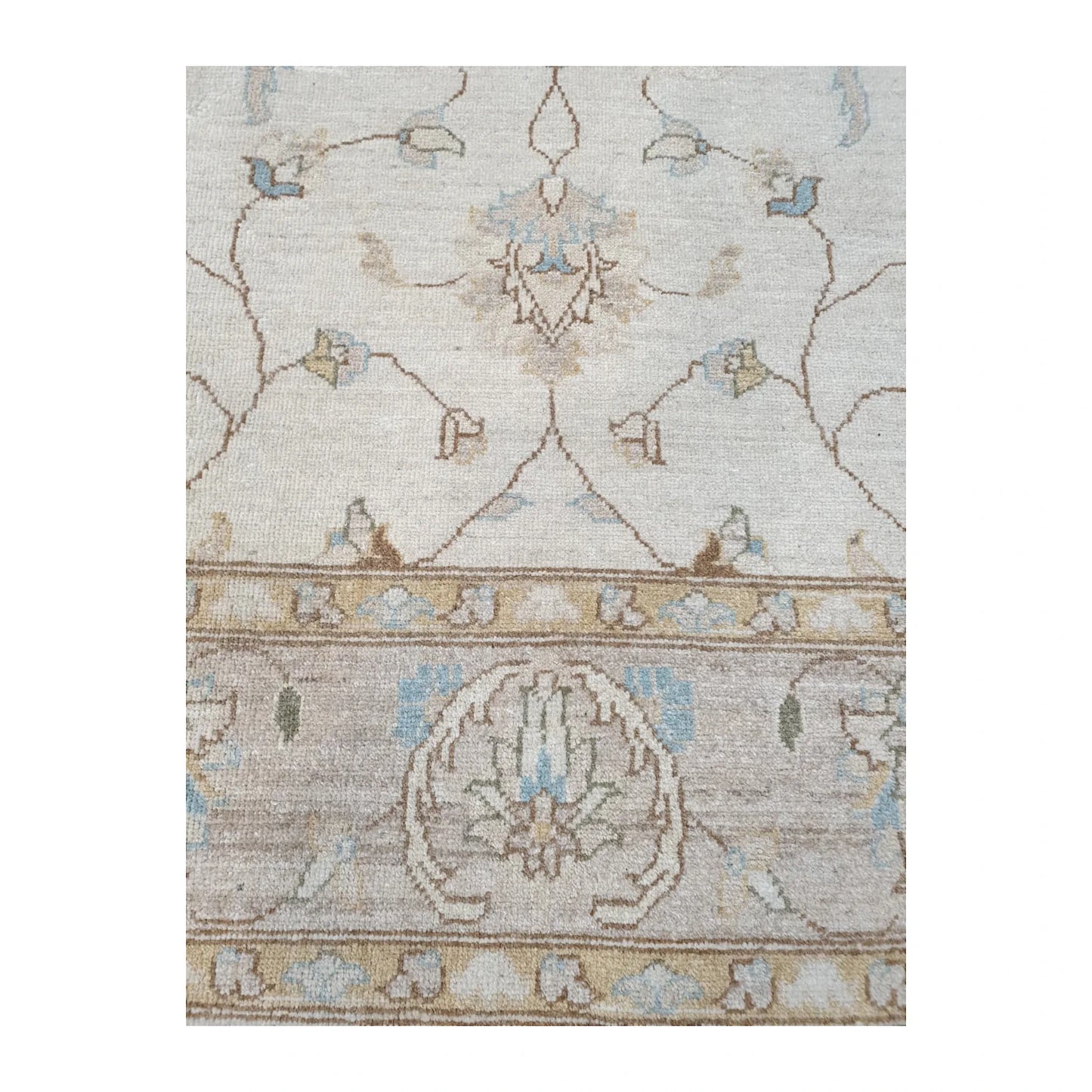 Field and border detail of Afghan Chobi rug showing tan vinework, stylised floral motifs and pale blue accents