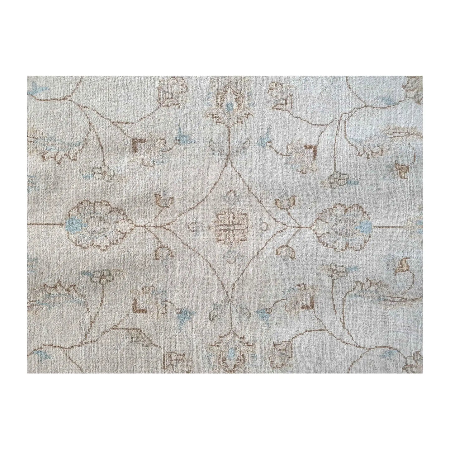 Field detail of Afghan Chobi soft beige rug showing subtle floral motifs