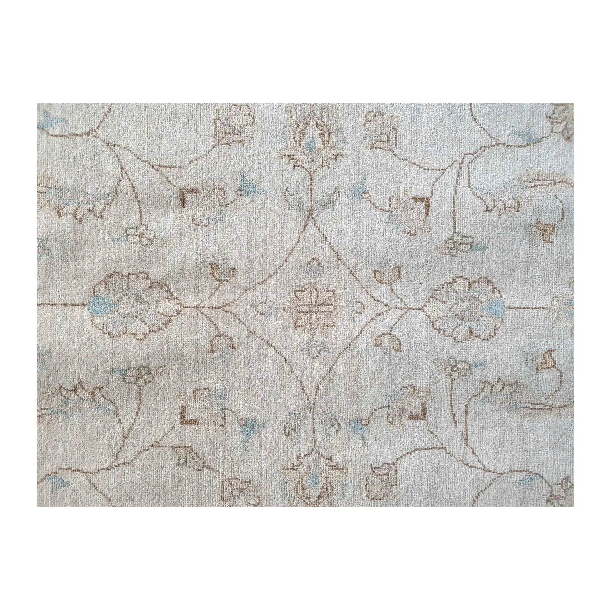 Field detail of Afghan Chobi soft beige rug showing subtle floral motifs