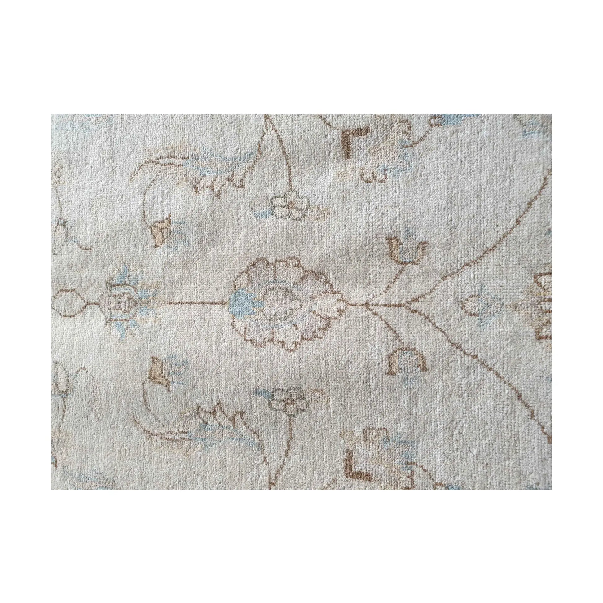Floral detail of Afghan Chobi rug showing soft beige wool pile and fine pattern