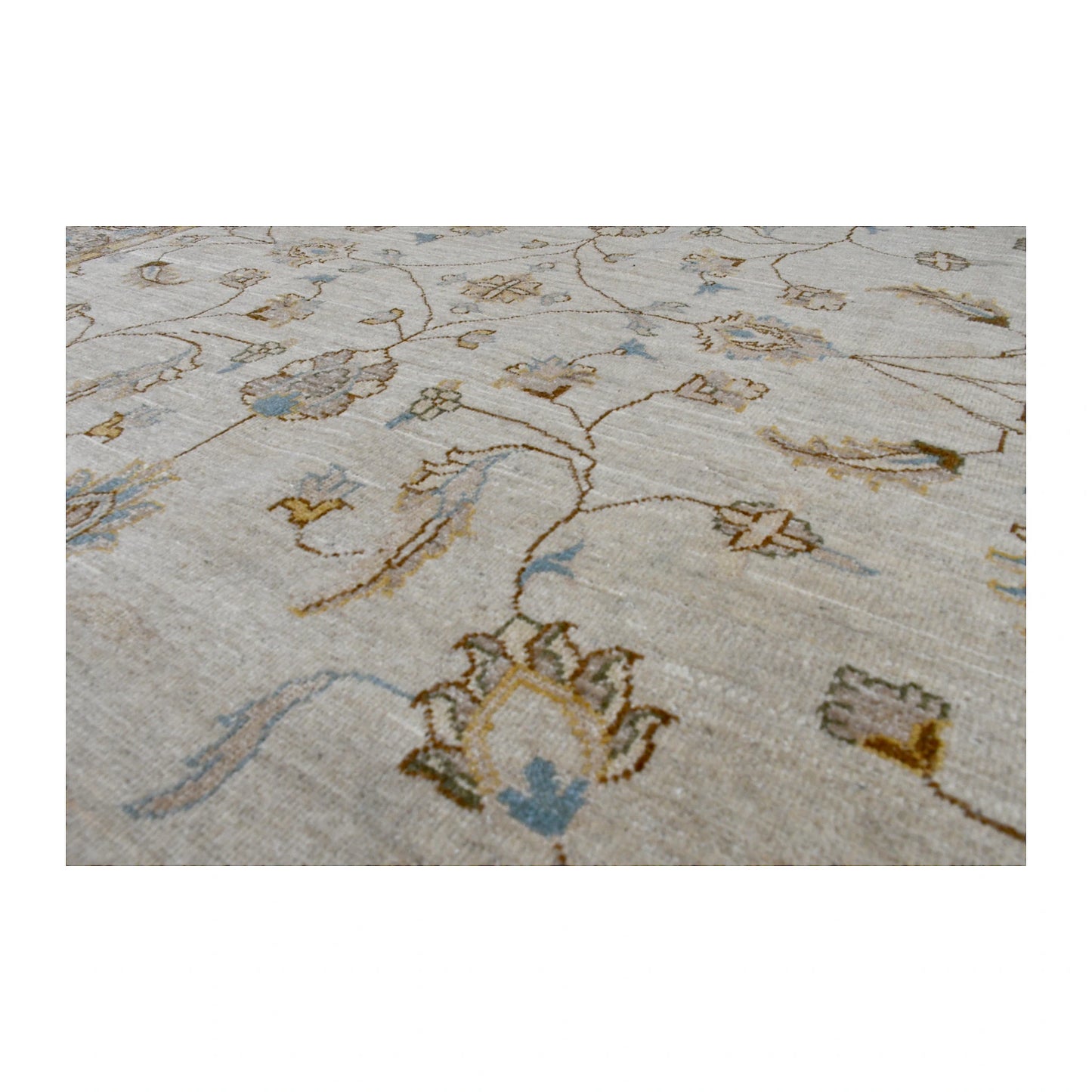 Angled close-up of Afghan Chobi soft beige rug showing the hand-knotted wool pile and delicate floral motifs in blue, gold and brown