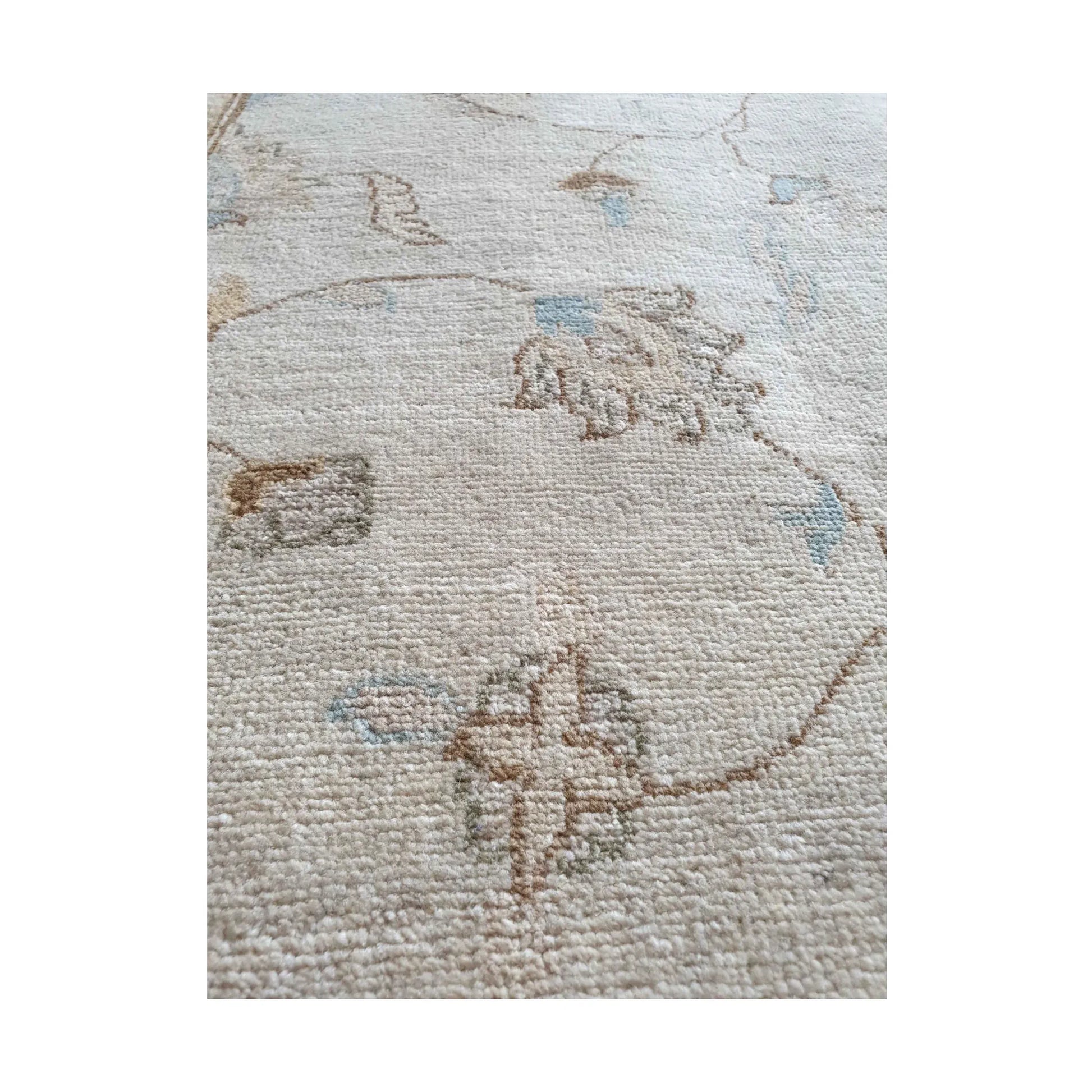 Motif detail of Afghan Chobi soft beige rug with muted red and blue accents