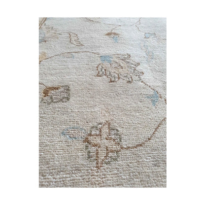 Motif detail of Afghan Chobi soft beige rug with muted red and blue accents