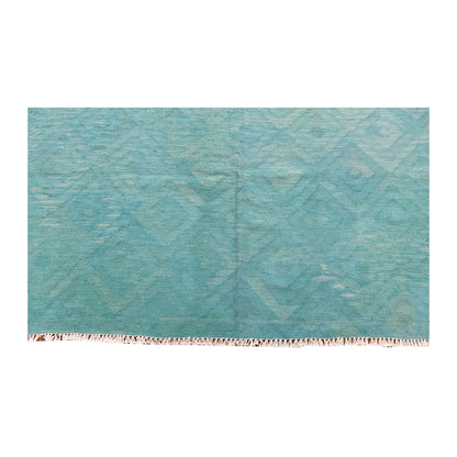 Fringe-end detail of Afghan Chobi kilim showing pale angular motifs within the blue-green diamond field