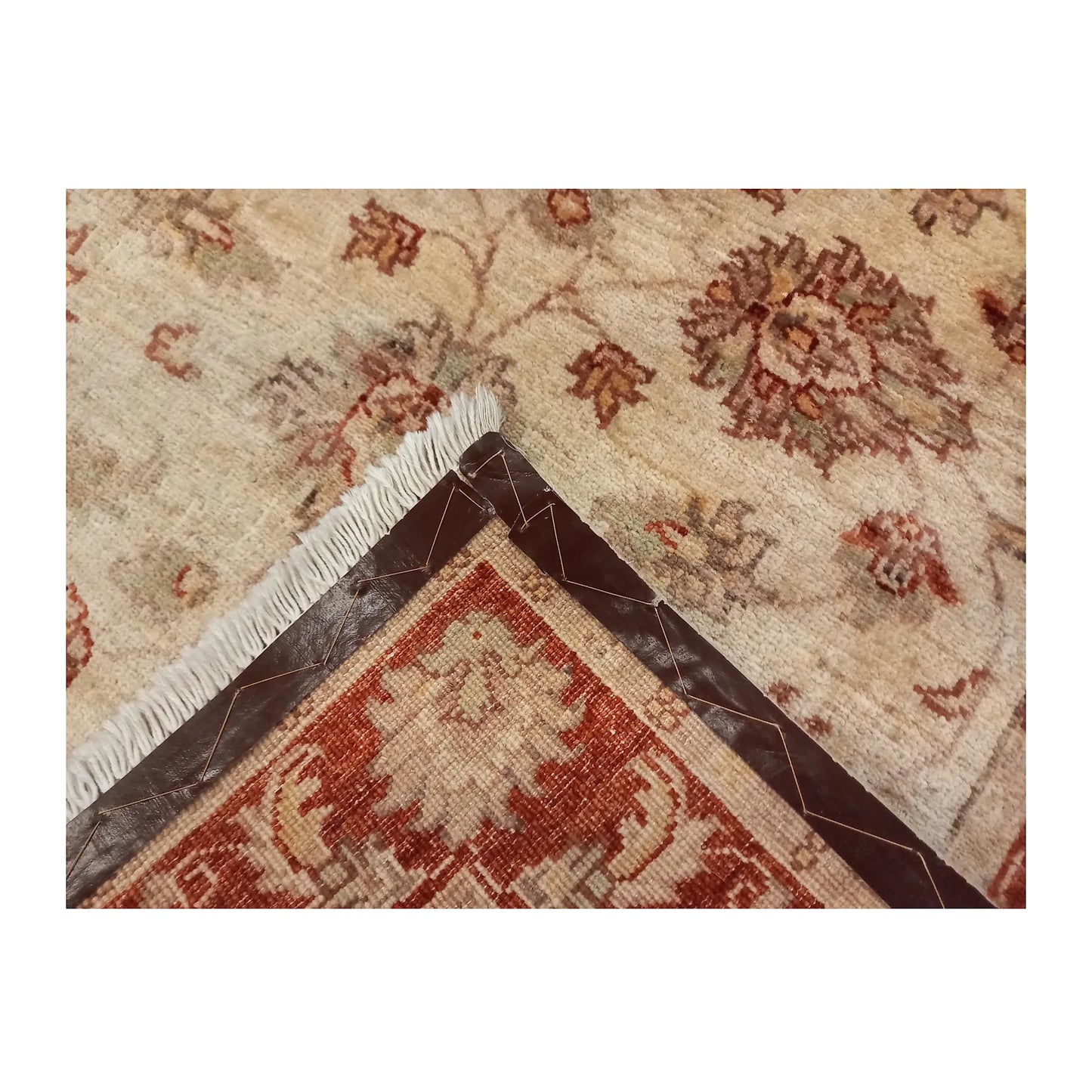 Folded corner showing the floral wool pile, reverse weave and reinforced backing edge
