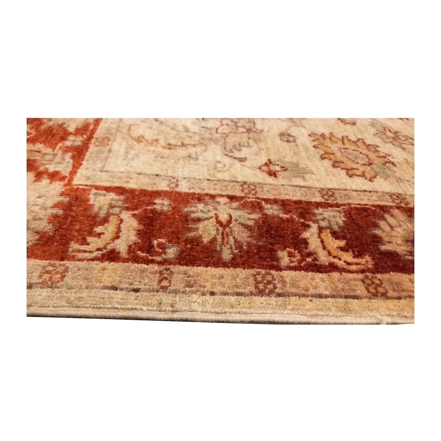 Close view of the rust-red floral border, narrow guard borders and wool pile edge