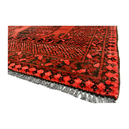 Angled corner and fringe view of Afghan Ersari wool rug showing red pile, border detail and light fringe
