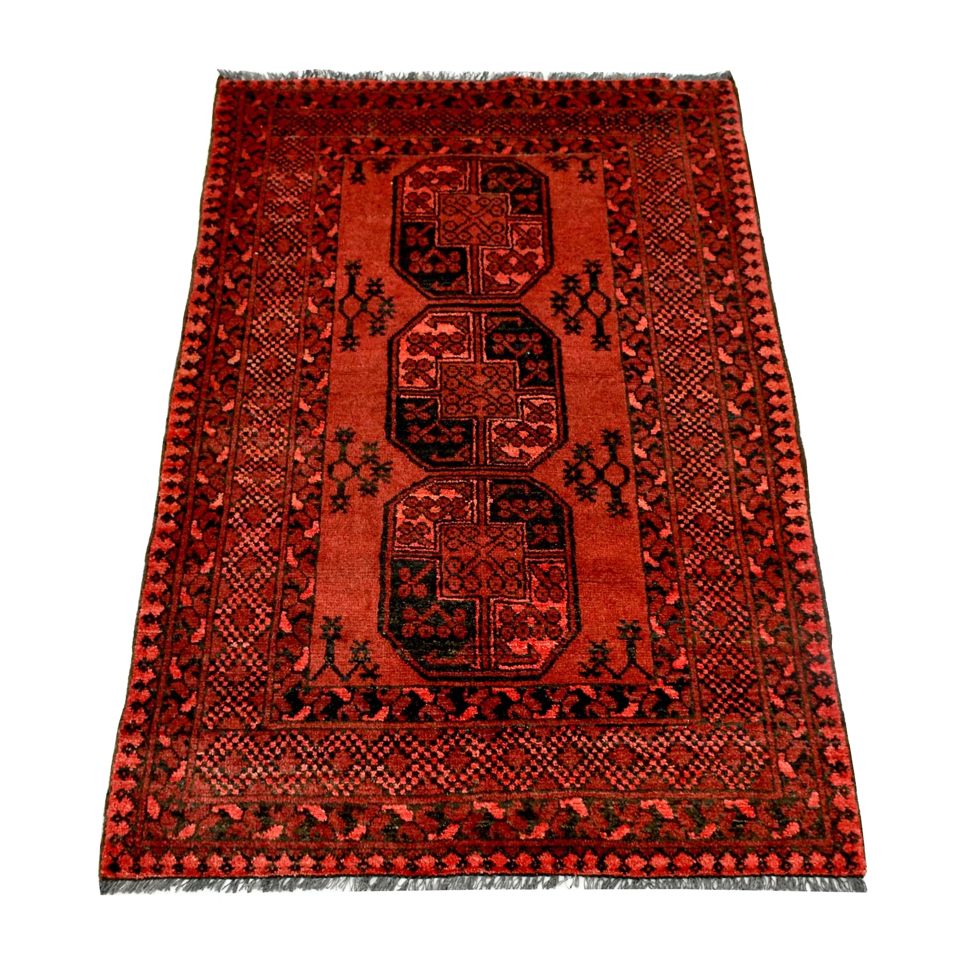 Angled full view of Afghan Ersari hand-knotted wool rug showing red field, dark motifs and geometric border, 155 x 105 cm