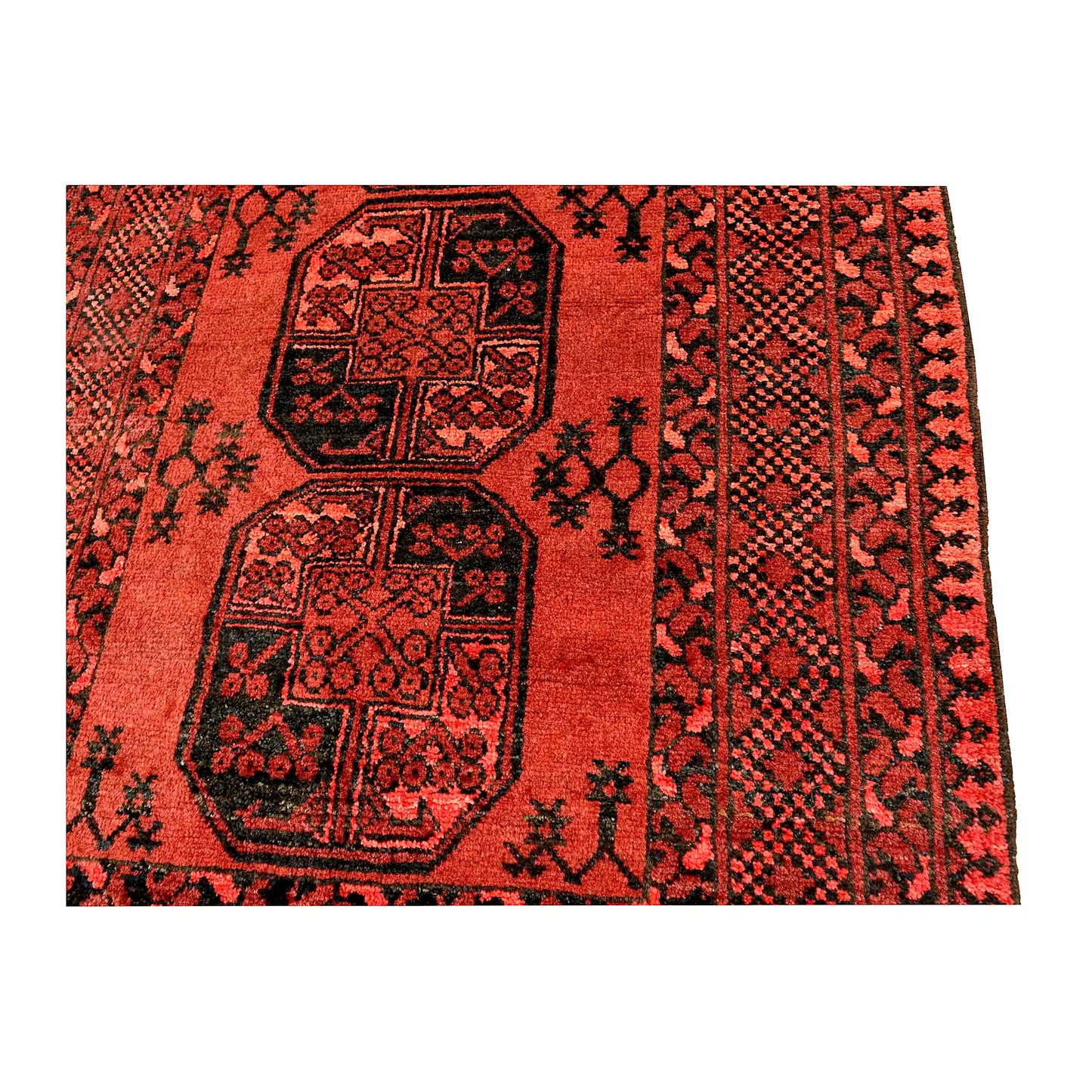 Field and border detail of Afghan Ersari hand-knotted wool rug showing central medallions and dark geometric patterning