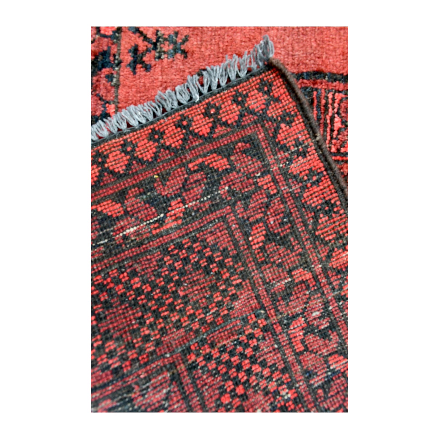 Reverse-weave and fringe detail of Afghan Ersari wool rug showing back structure and hand-knotted pattern