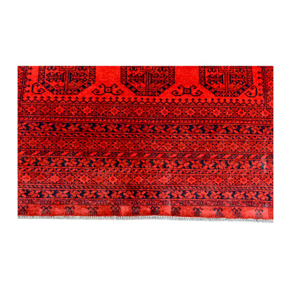 End-border detail of Afghan Ersari rug showing repeated geometric bands in deep red, burgundy, terracotta and charcoal