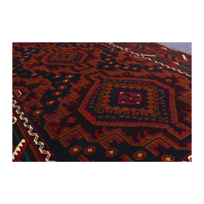 Close-up of Afghan Fine Baluchi rug showing a stepped diamond medallion and wool pile texture