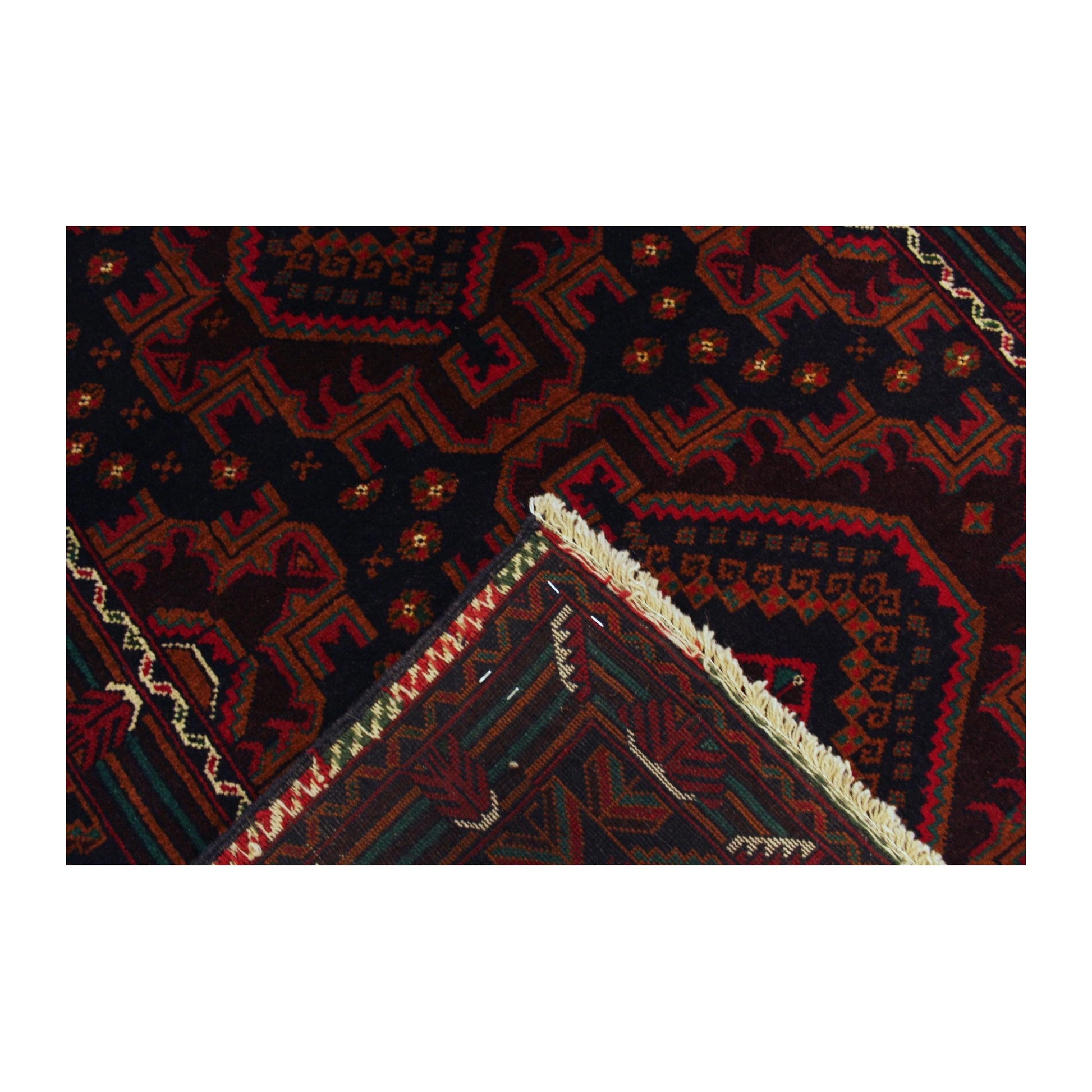 Folded-corner detail of Afghan Fine Baluchi rug showing the patterned field, border and reverse weave