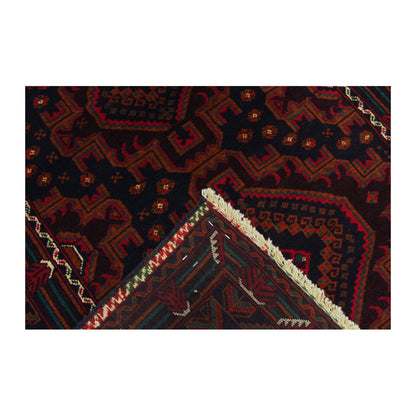 Folded-corner detail of Afghan Fine Baluchi rug showing the patterned field, border and reverse weave
