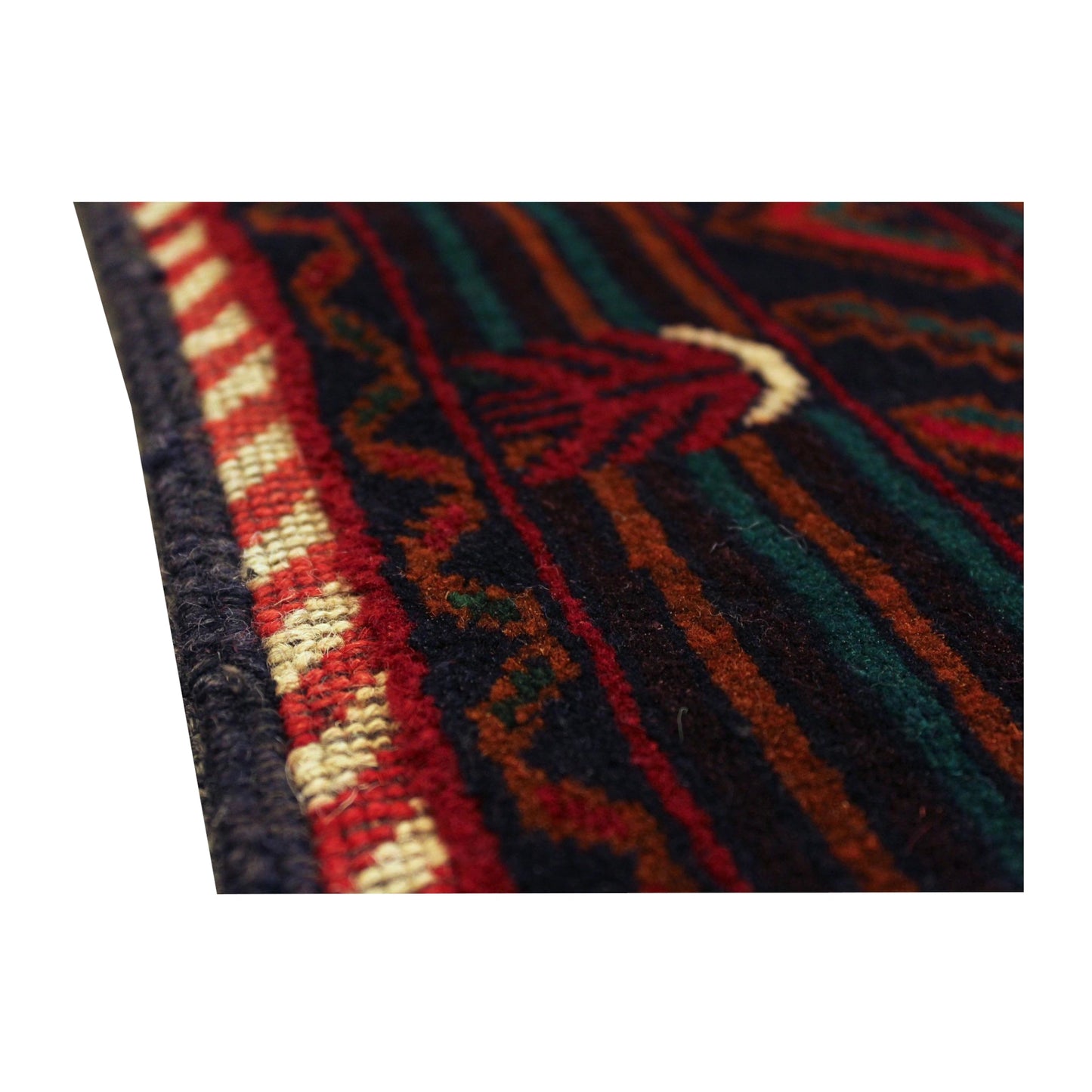 Low-angle side-edge detail of Afghan Fine Baluchi rug showing the border stripes and wool pile texture