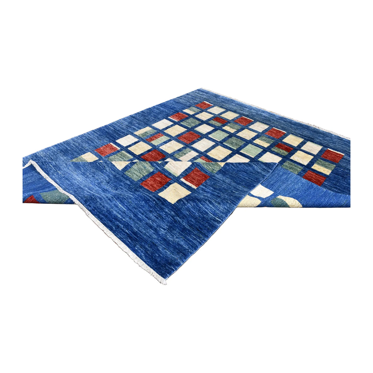 Angled view of the Afghan Gabbeh rug with a blue corner folded across part of its colour-block grid