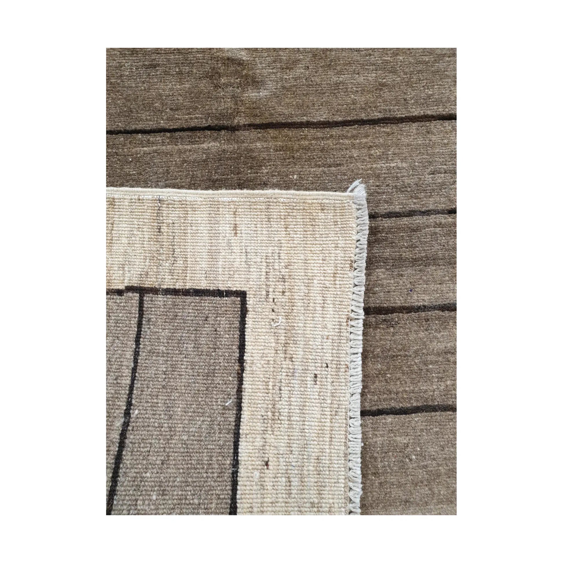Back corner detail of Afghan Gabbeh hand-knotted wool rug showing reverse weave, cream border and natural wool structure, 166 x 106 cm