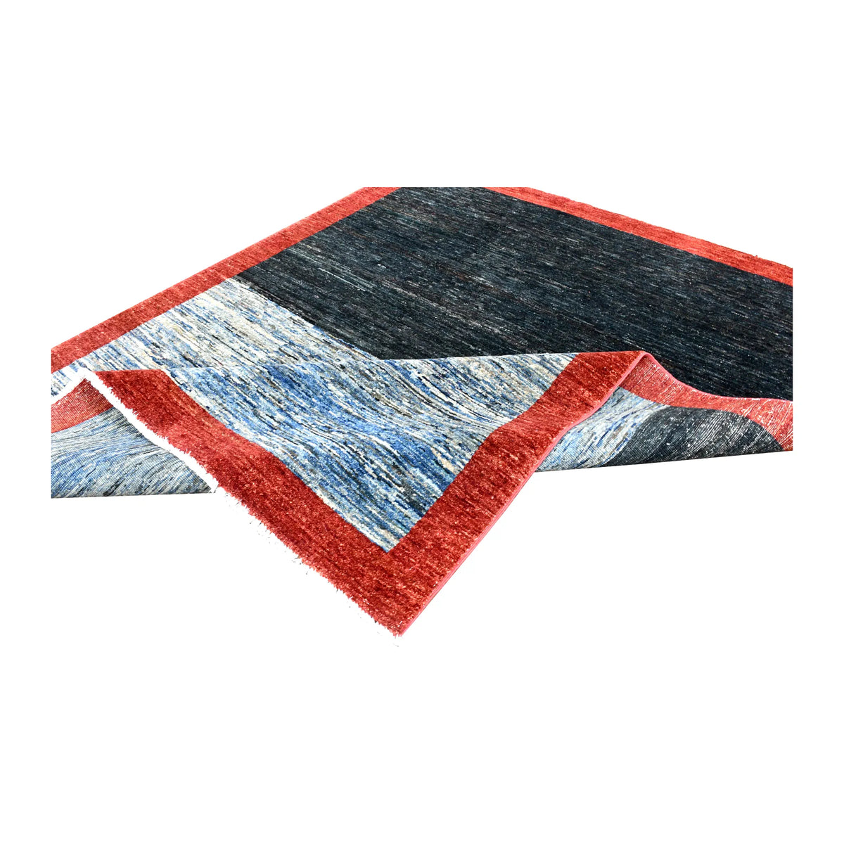 Folded view of Afghan Gabbeh hand-knotted wool rug showing its red border, navy and blue field and pale fringe