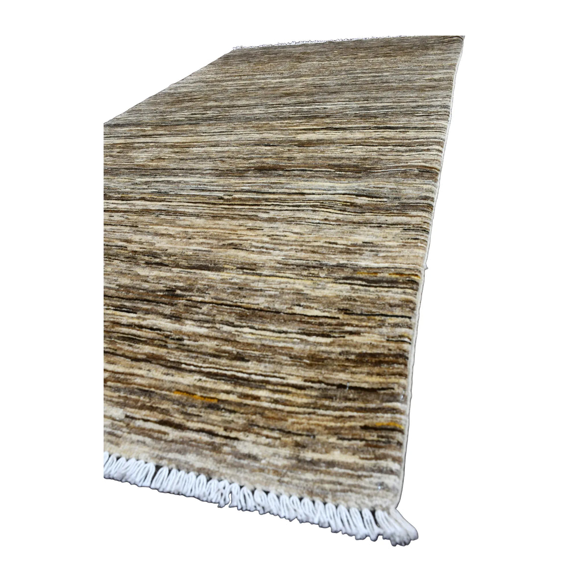 Angled view of Afghan Gabbeh wool rug showing its naturally varied striated field and pale fringe