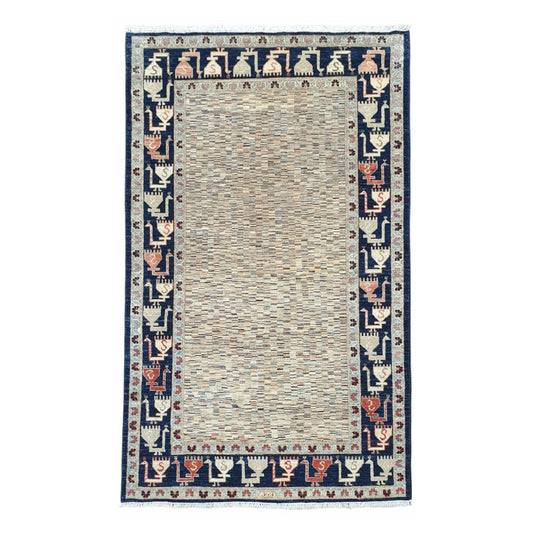 Full view of Afghan Gabbeh hand-knotted wool rug with variegated ivory field and deep navy border, 234 x 142 cm